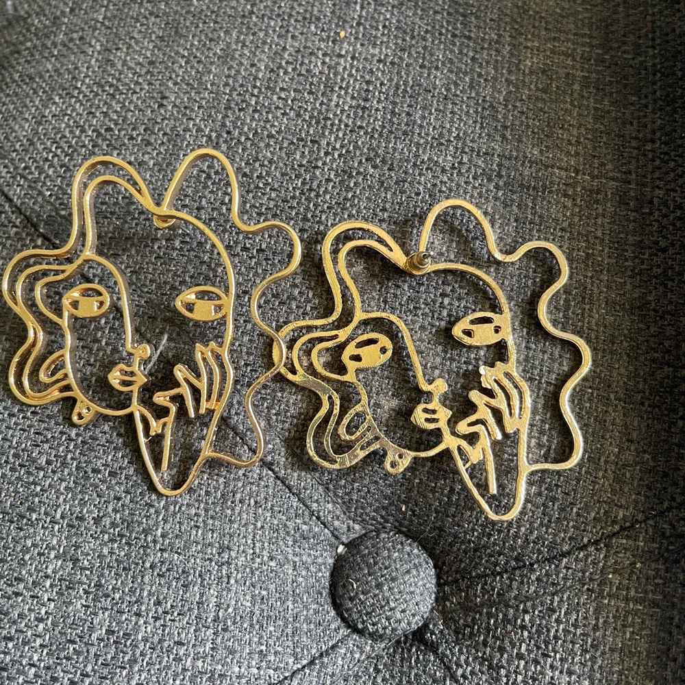 Gold face earrings